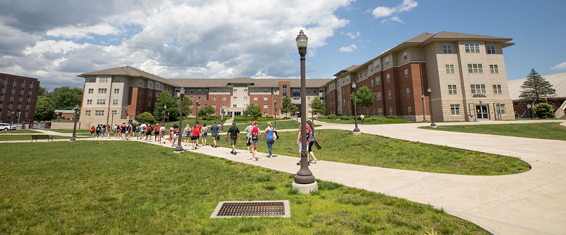 student walking towards dorms