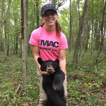 Graduate Student Kristine Bentkowski holding a yearling bear