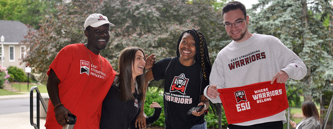 4 Students laughing and wearing ESU shirts