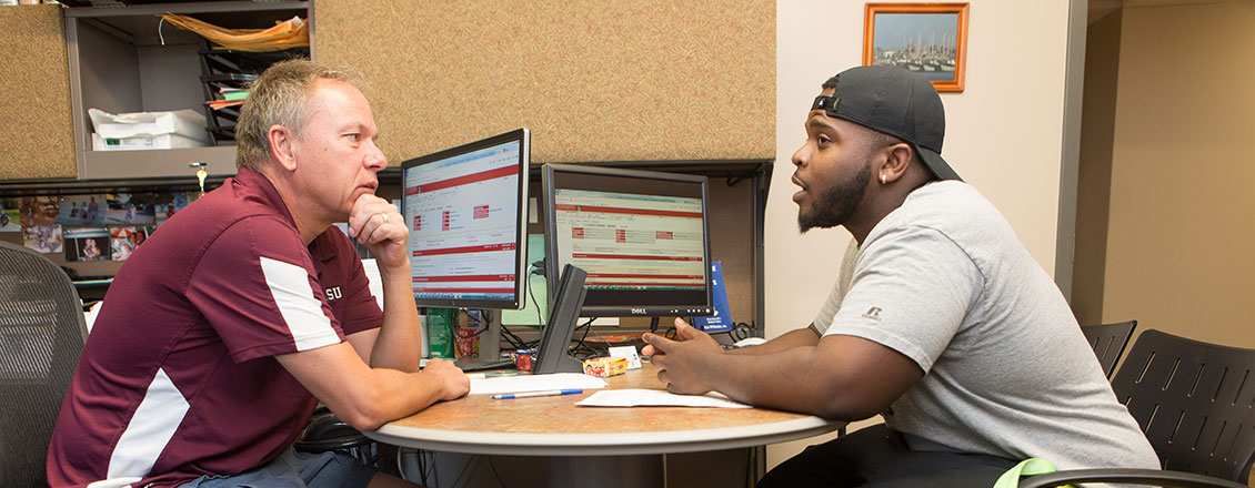 A student talking with a faculty member during an advising session
