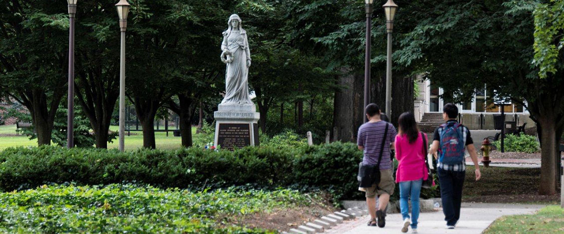 ESU's Julia statue with students walking past