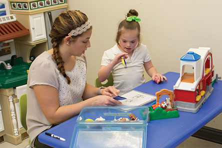 a teacher instructing a small child