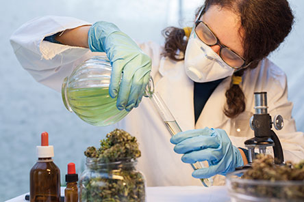 scientist with facemask on doing an experiment