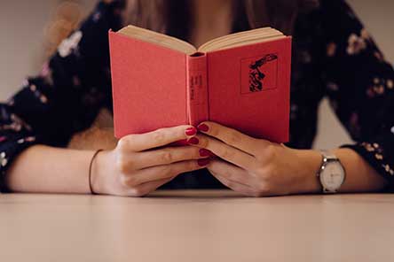 Woman reading an antique book