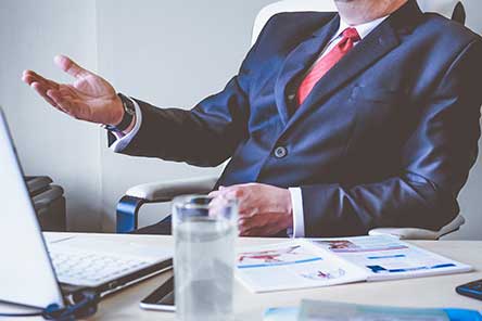 A man in a suit gesturing