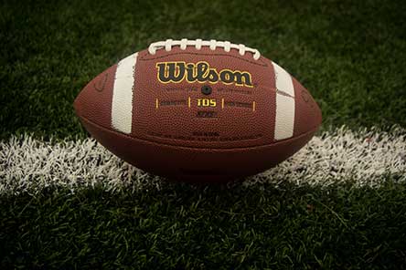 A football sitting on a painted yard line