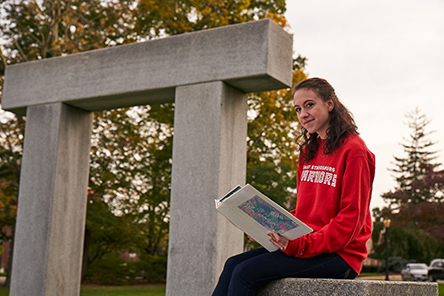 Student sitting near Stroud Hedge