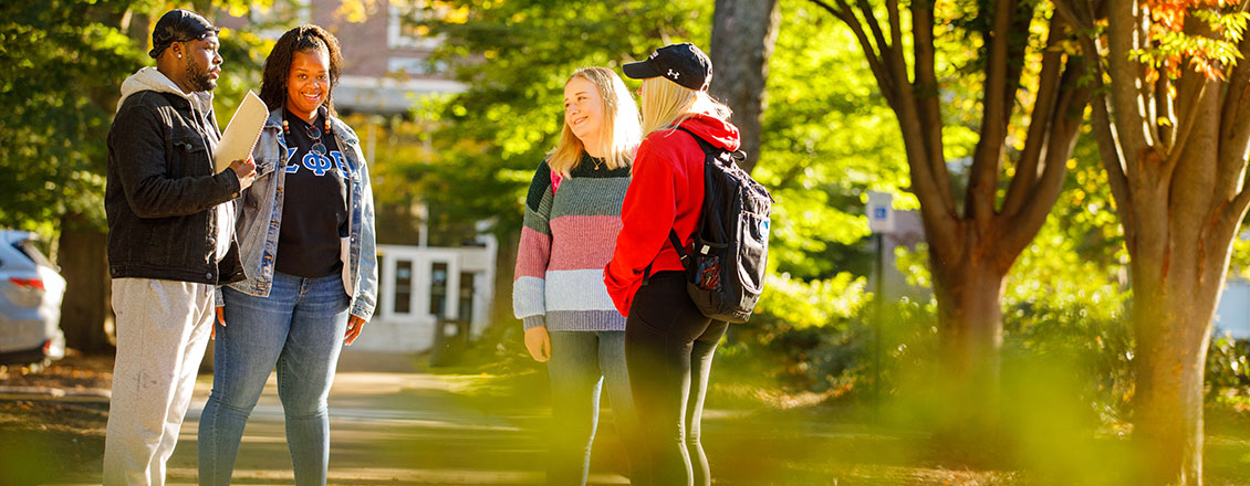 4 students standing in front of stroud hall