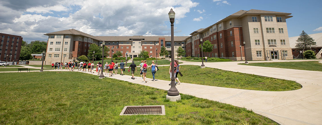 student walking towards dorms