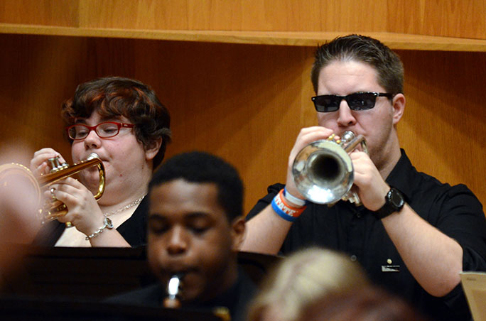 two students playing trumpet