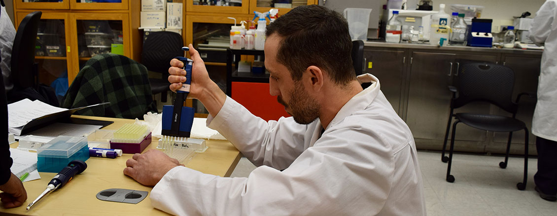 male student doing experiments