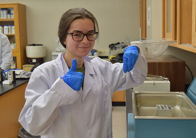 female biotech student doing experiment