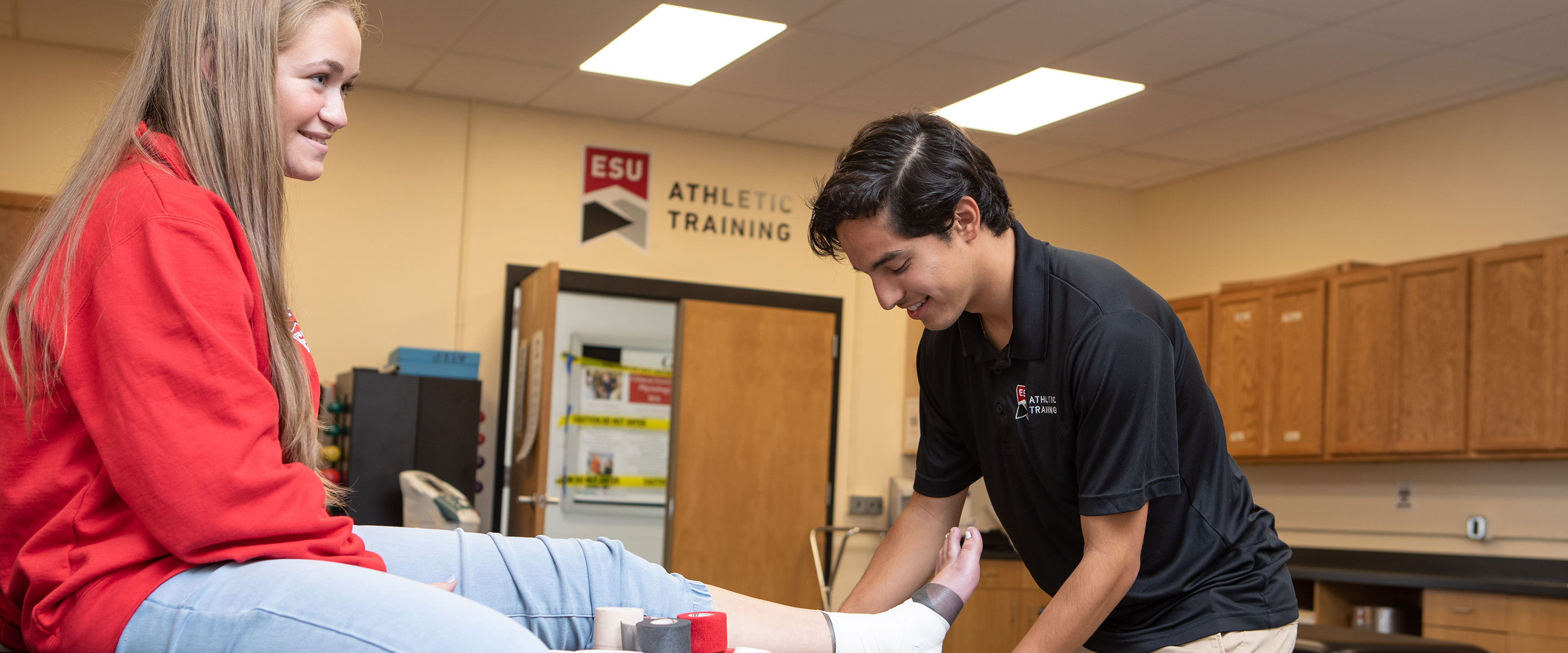 student wrapping ankle on student patient