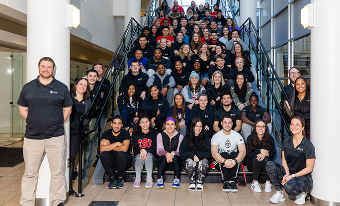 entire staff of rec center sitting on stairs