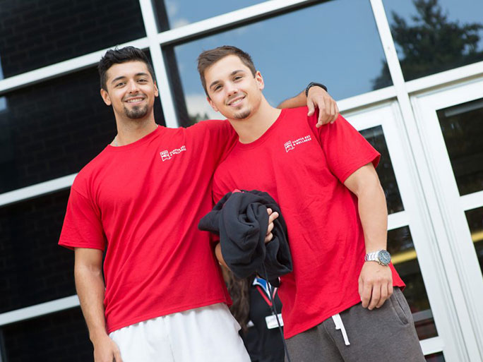 two students standing in front of rec center