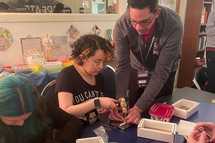 teacher demonstrating experiment to student