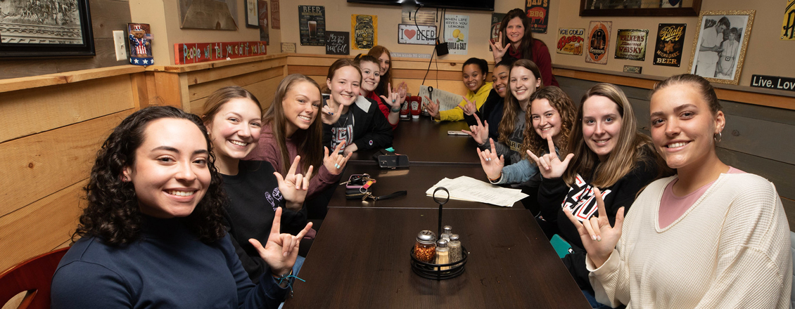 two girl doing sign language