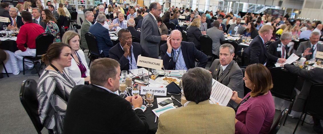 Attendees at a table discussing infrastructure at the 2018 Economic Outlook Summit