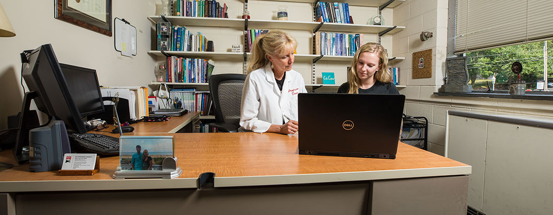 Dr. Davis with student in office