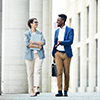 two people walking outside talking