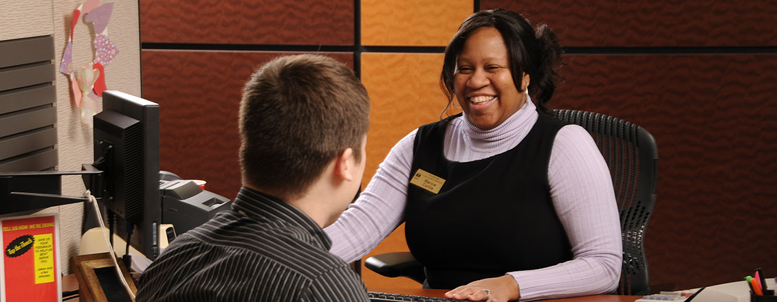 Student Enrollment Center staff member speaking with a student