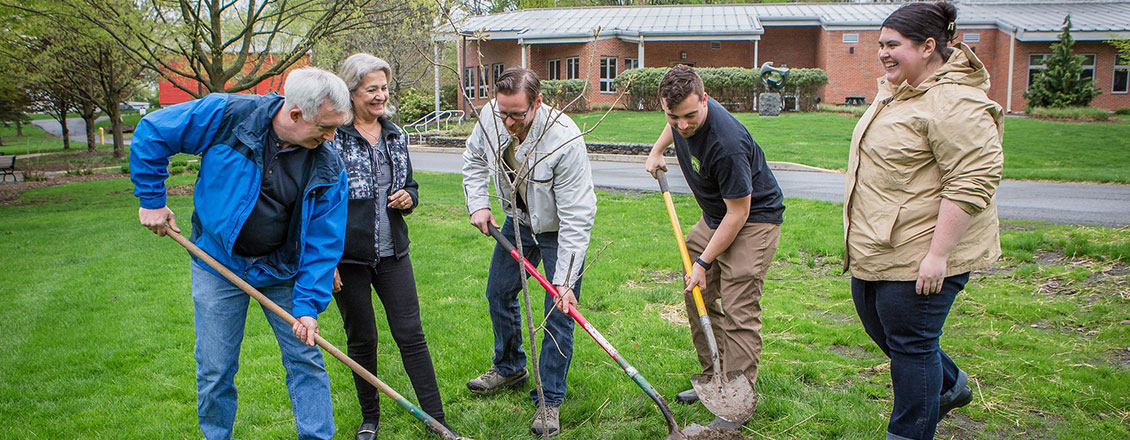 Green Initiative group planting tree on arbor day