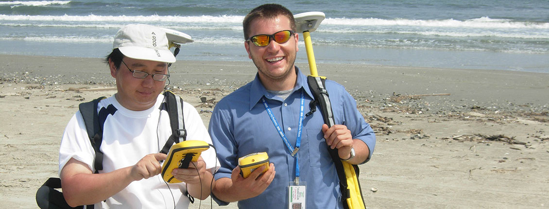 Two men using GIS equipment