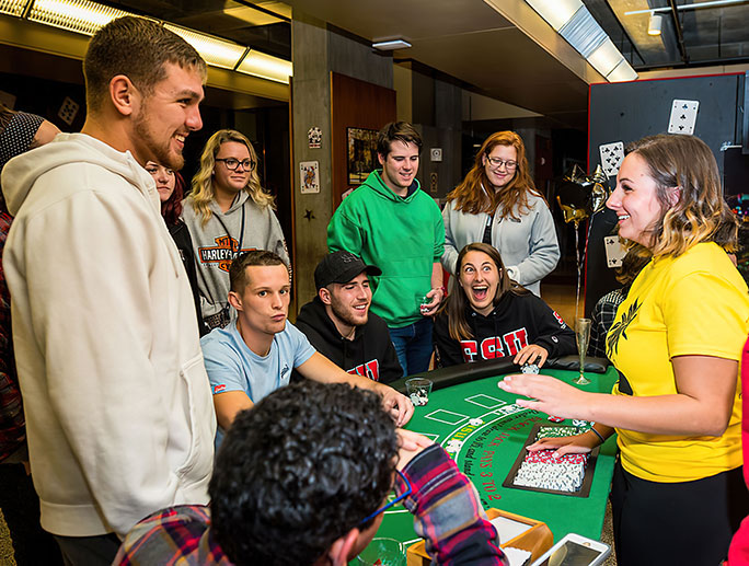 Students gathered around a casino table