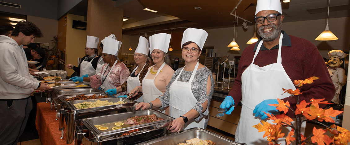 staff serving thanksgiving meal to students