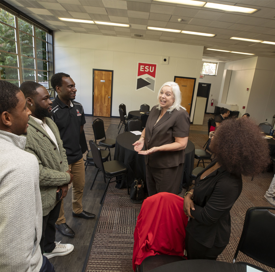 Students talking with staff at event