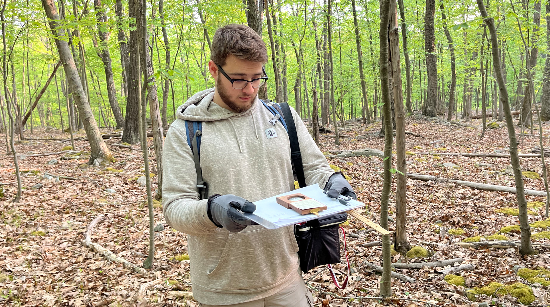 Student researching in the woods