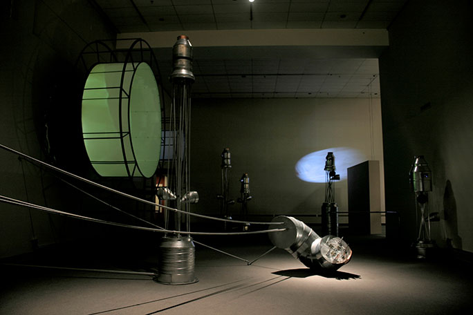 Margaret Cogswell -  A view of the art installation from Mississippi River Fugues with industrial equipment and projected images 