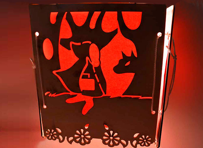 This is a laser cut lantern in red with a red riding hood theme