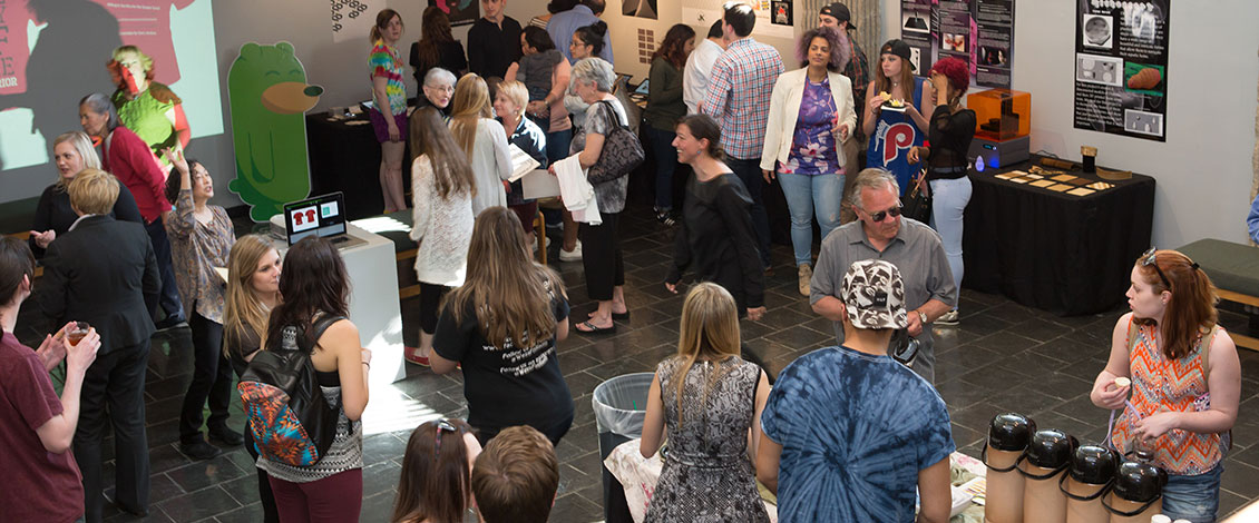 People standing and discussing art in the gallery