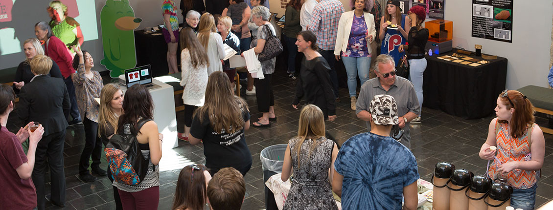 People standing and discussing art in the gallery