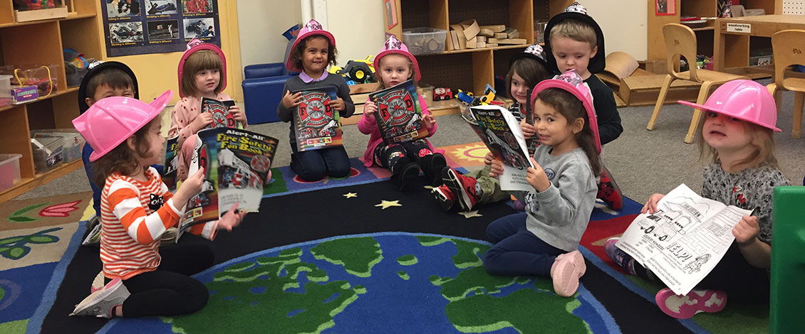 Children wearing costume fire helmets