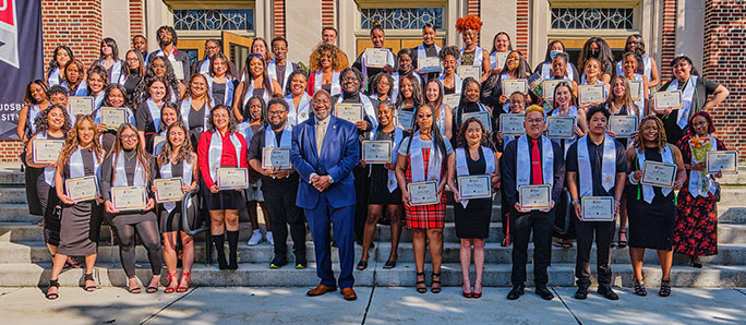 students dress for commencement