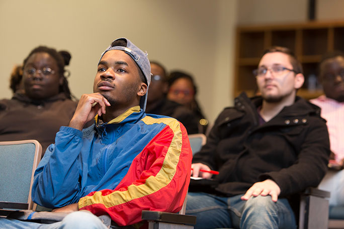 Students sitting and listening to a speaker