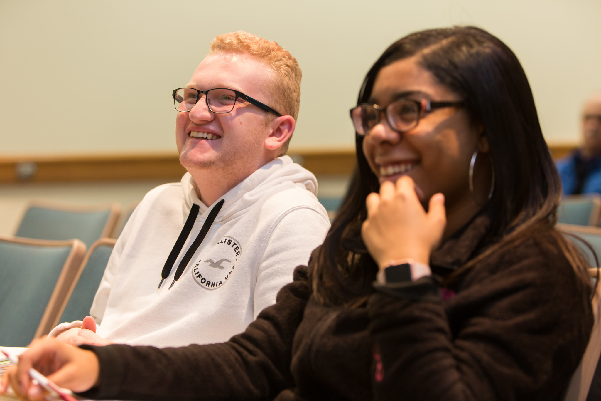 Two students listening to a Black History Month speaker