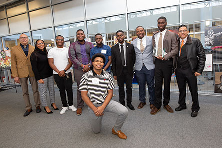 Students and staff of color standing together