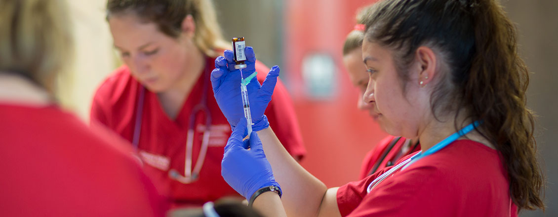 nursing student filing syringe