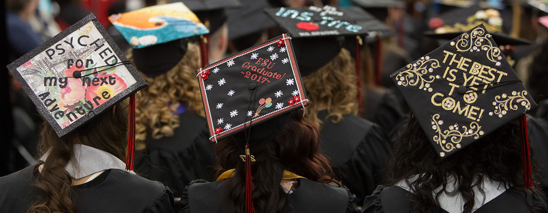 Students wearing decorated caps at commencement