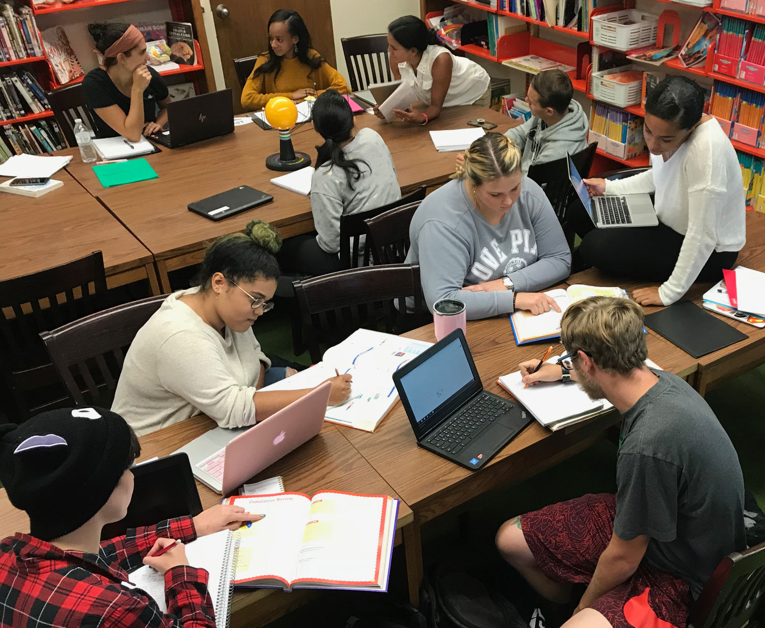 Students studying together around two tables