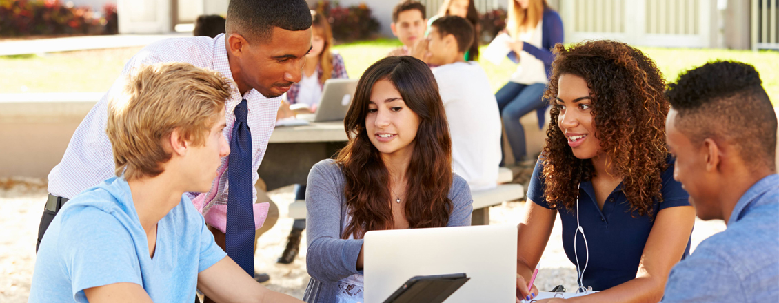 students sitting at desk taking notes during class