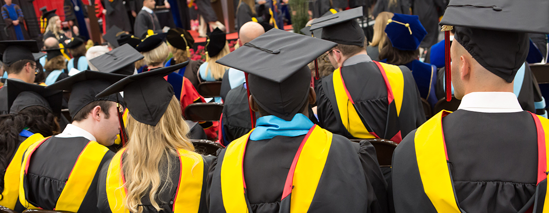the backs of graduate students during commencement