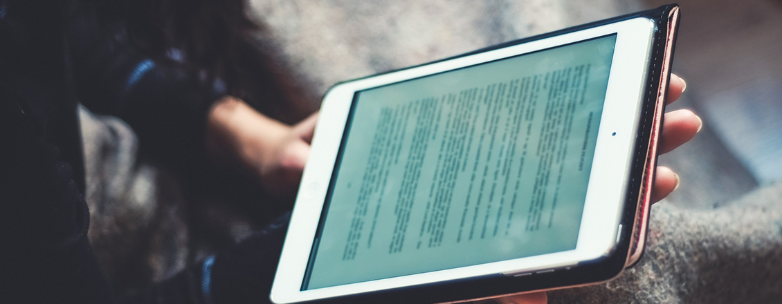 student reading from tablet