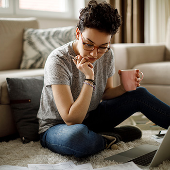 Woman rreviewing notes by her laptop