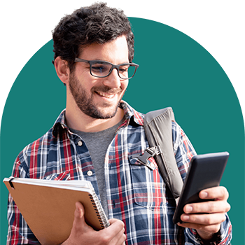 boy looking at phone while holding books