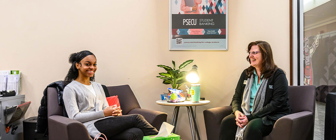 female student and director of psecu sitting in chairs