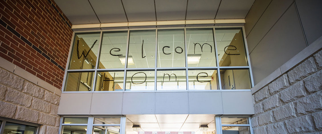 welcome home painted on window of dorm